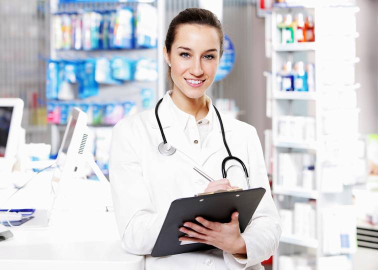 Female pharmacist holding a tablet in a pharmacy