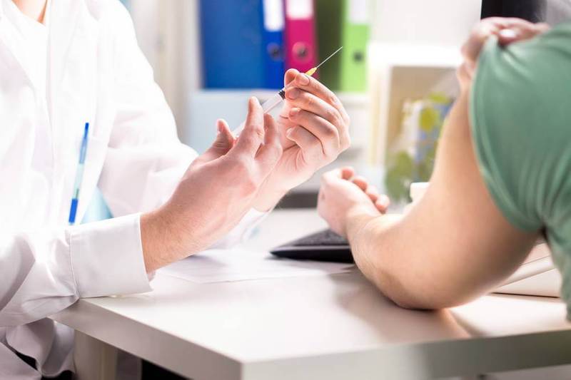 A pharmacist preparing to administer a vaccine